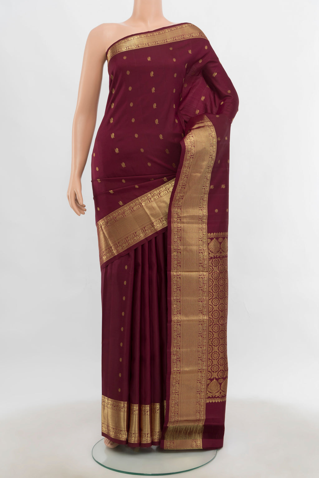 Pure Silk Pure Zari Maroon Kanchipuram Saree with Zari Butta on the body and Silk Border.  displayed on a mannequin