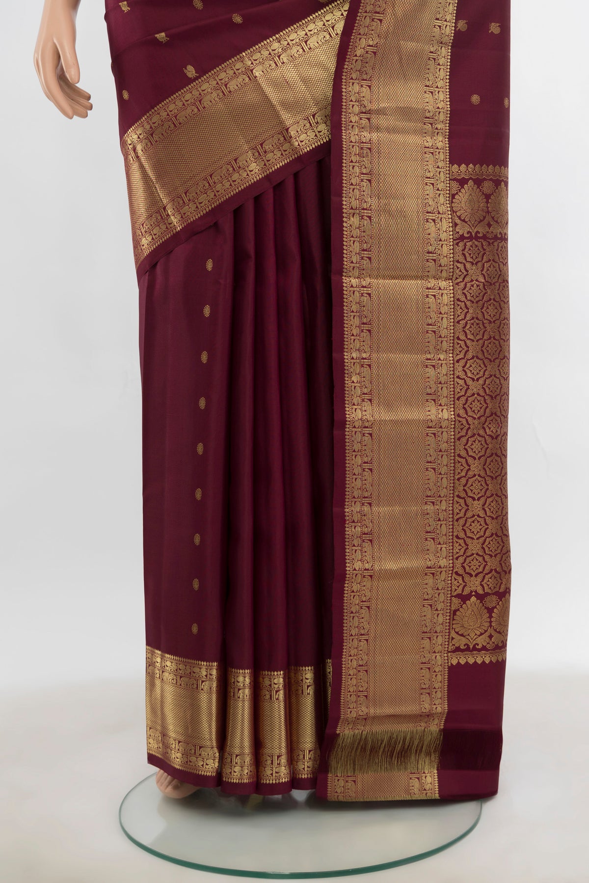 Pleats and pallu of Pure Silk Pure Zari Maroon Kanchipuram Saree with Zari Butta on the body and Silk Border. 
