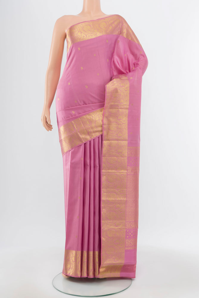 Pure Silk Pure Zari Rose Gold Kanchipuram Saree with Zari Brocade on the body and Silk Border.  displayed on a mannequin