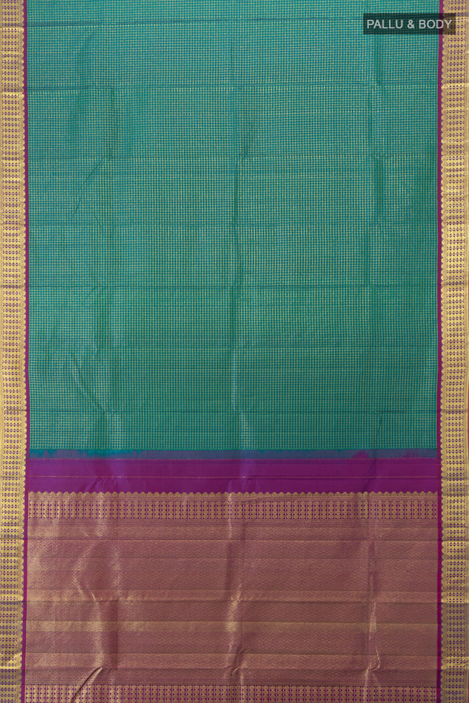 Flat view of Peacock Blue Kanjivaram Silk Saree with Zari Butta on the body and Silk Border. 