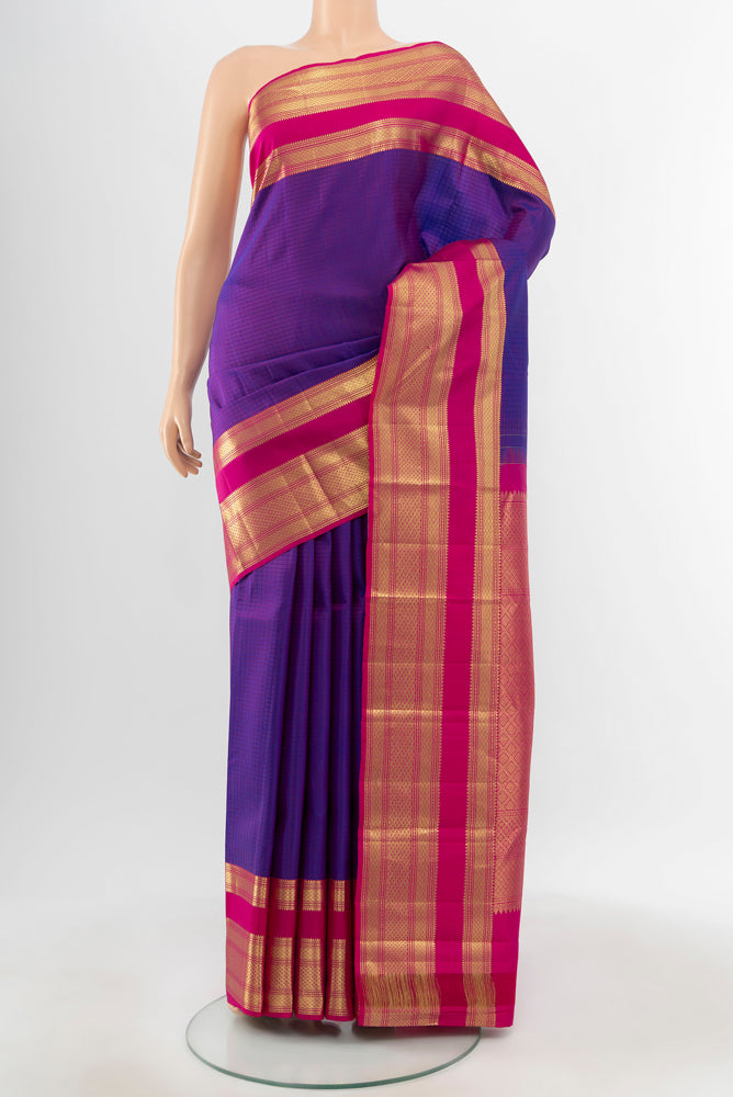 Pure Silk Pure Zari Purple Kanjivaram Saree with Zari Butta on the body and Silk Border.  displayed on a mannequin