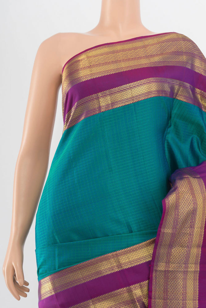 Border image of Peacock Blue Kanjivaram Silk Saree with Zari Butta on the body and Silk Border. 