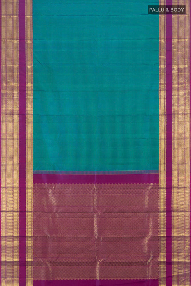 Flat view of Peacock Blue Kanjivaram Silk Saree with Zari Butta on the body and Silk Border. 
