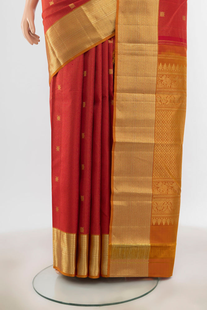 Pleats and pallu of Maroon Kanjivaram Silk Saree with Zari Butta on the body and Silk Border. 
