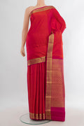Pure Silk Brick Orange Kanjivaram Saree with Jacquard design on the body and Zari Border.  displayed on a mannequin