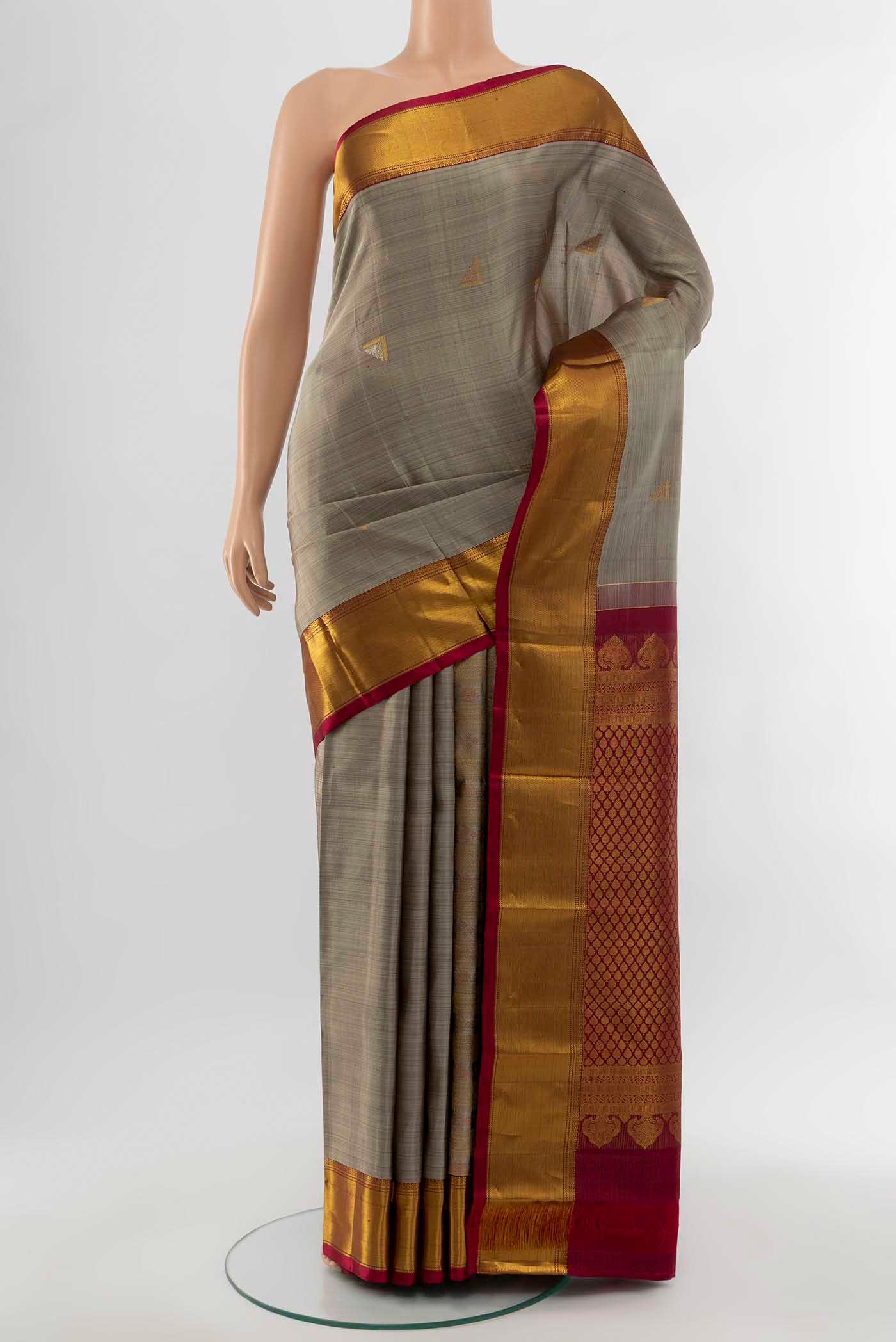 Bronze Kanchipuram Silk Saree with Zari Butta on the body and Silk Border displayed on a mannequin