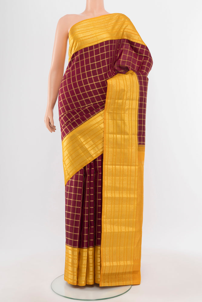 Maroon Kanchipuram Silk Saree with Zari Butta on the body and Silk Border.  displayed on a mannequin
