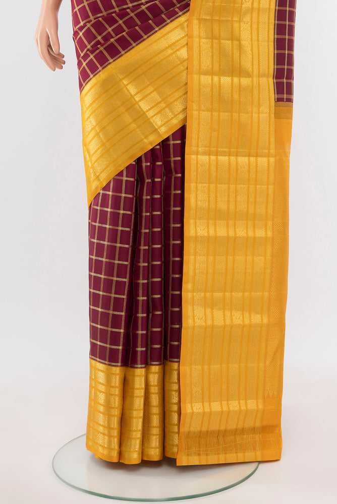 Pleats and pallu of Maroon Kanchipuram Silk Saree with Zari Butta on the body and Silk Border. 