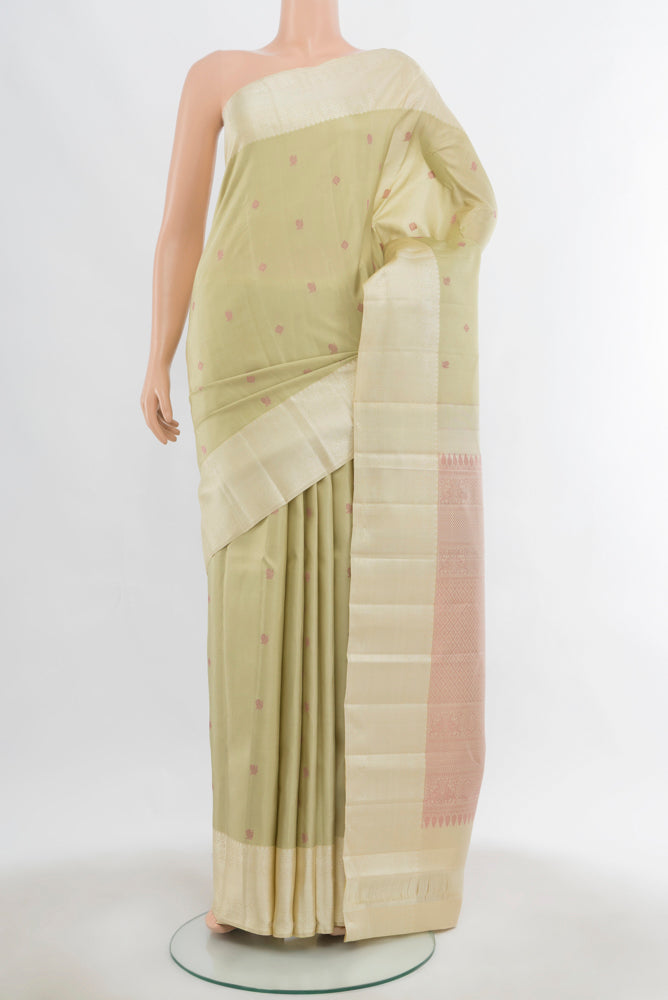Light Green Kanchipuram Silk Saree with Zari Butta on the body and Silk Border.  displayed on a mannequin