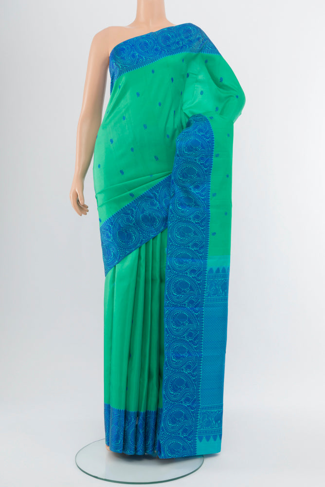 Sky Blue Kanchipuram Silk Saree with Zari Butta on the body and Silk Border.  displayed on a mannequin