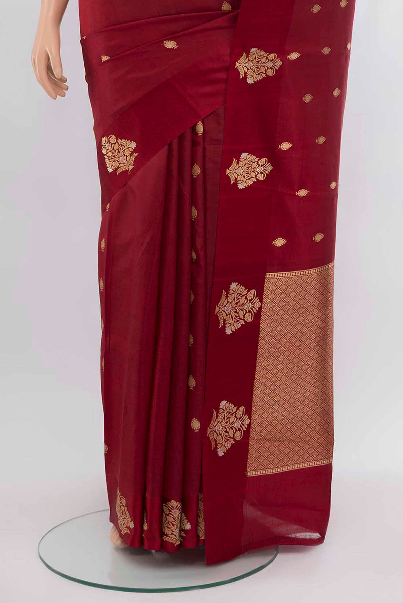 Pleats and pallu of Maroon Banarasi Katan Silk Saree with Zari Butta on the body and Silk Border. 