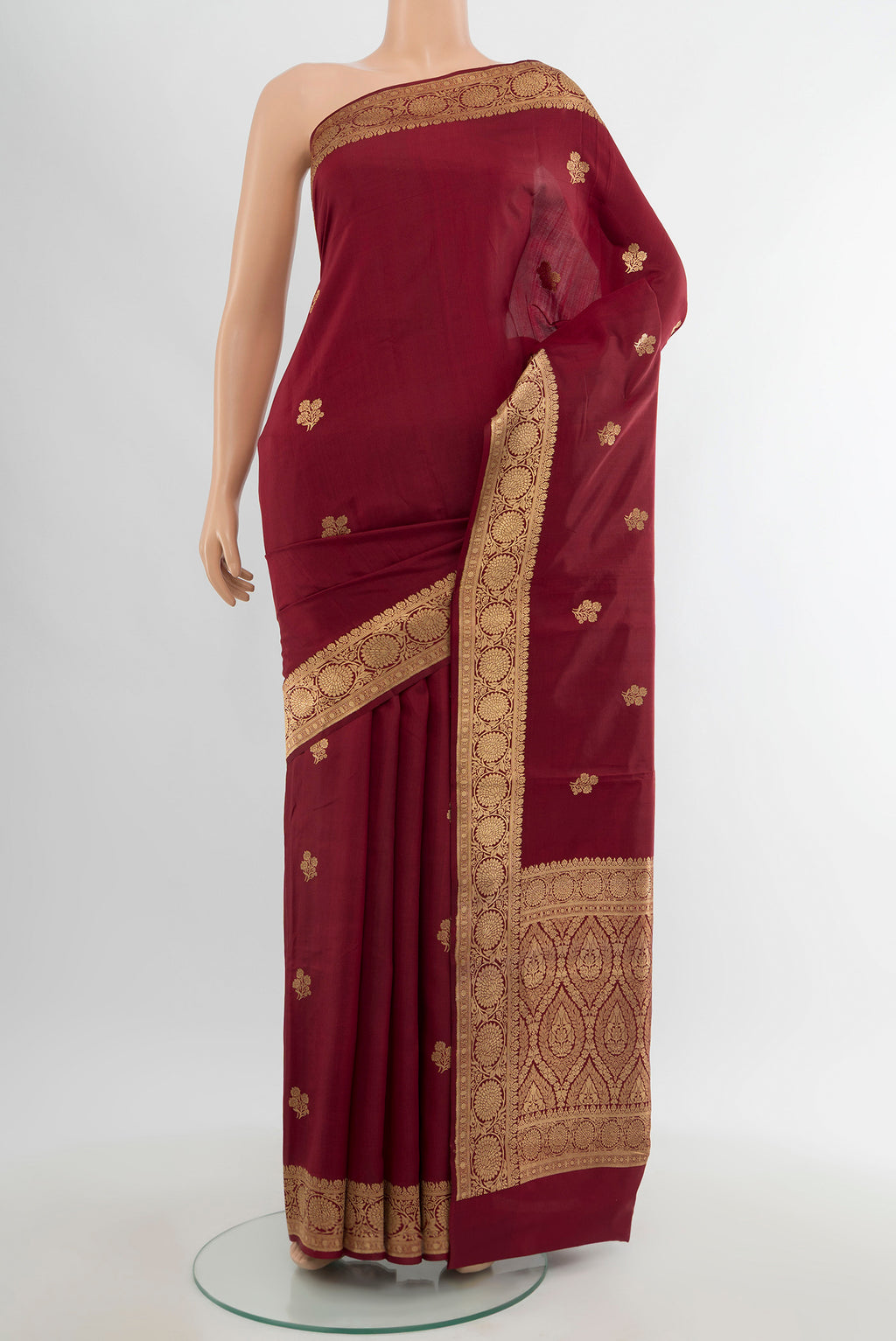 Maroon Banarasi Katan Silk Saree with Zari Butta on the body and Zari Border.  displayed on a mannequin