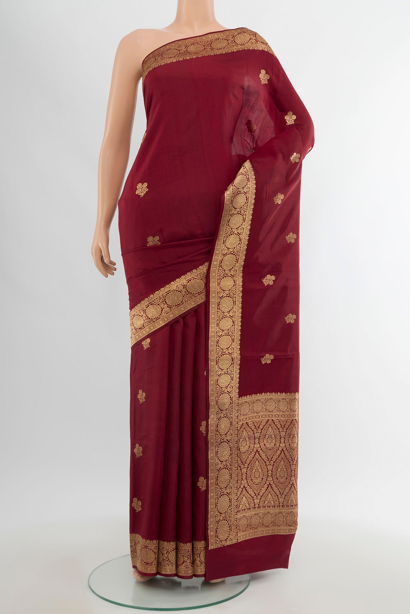 Maroon Banarasi Katan Silk Saree with Zari Butta on the body and Zari Border.  displayed on a mannequin