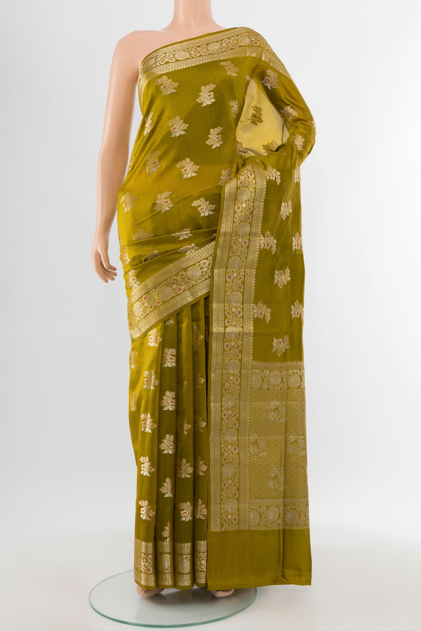 Pure Silk Pure Zari Mehandi Green Banarasi Raw Saree with Zari Butta on the body and Silk Border.  displayed on a mannequin