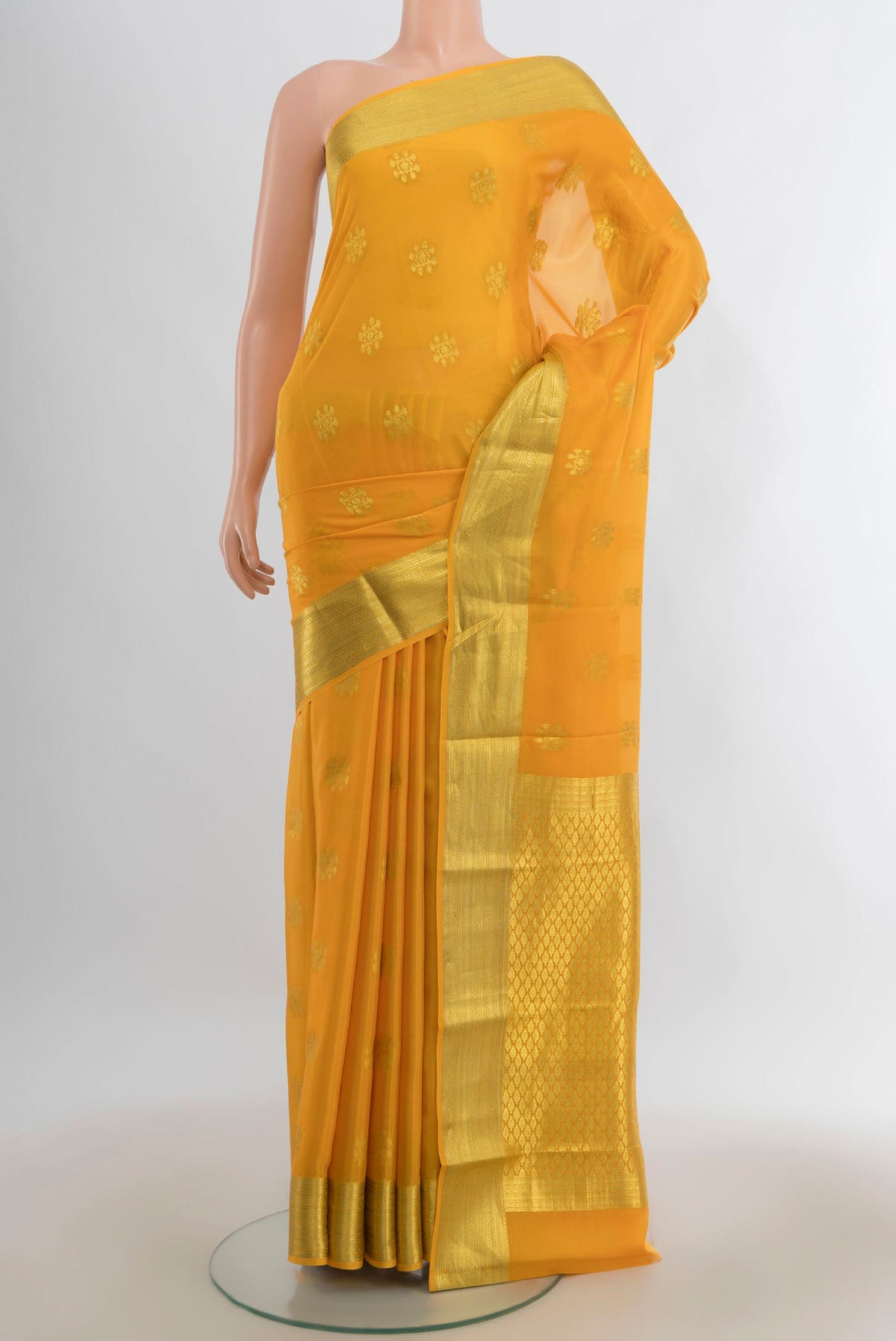 Yellow Mysore Crepe Saree with Zari Butta on the body and Zari Border.  displayed on a mannequin