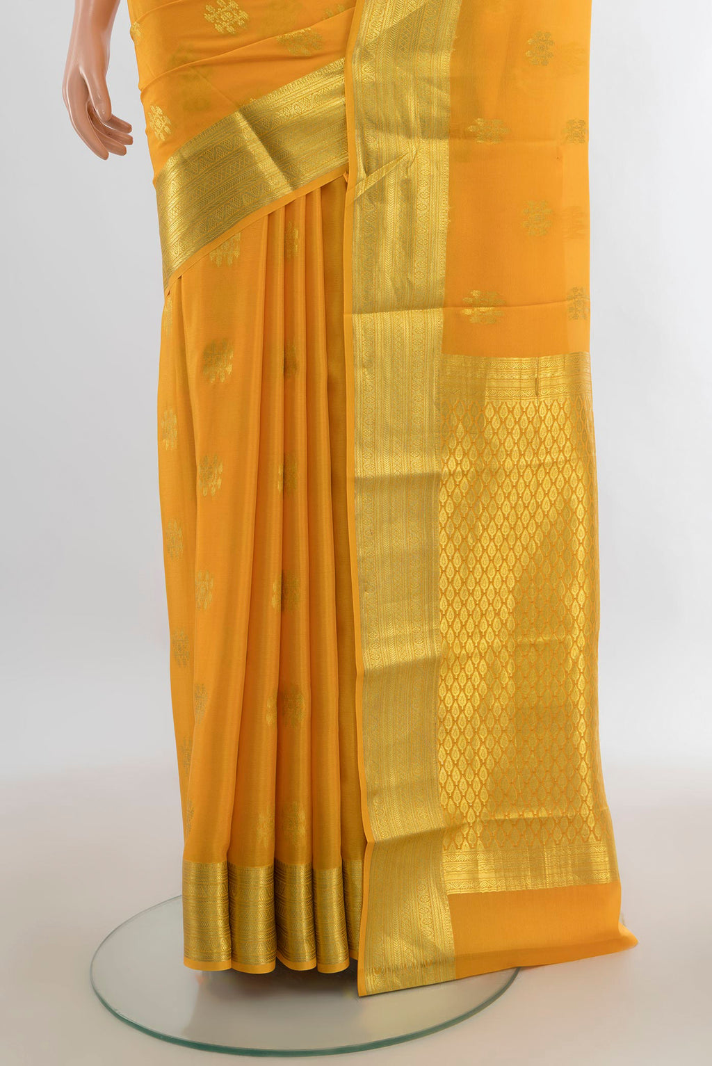 Pleats and pallu of Yellow Mysore Crepe Saree with Zari Butta on the body and Zari Border. 