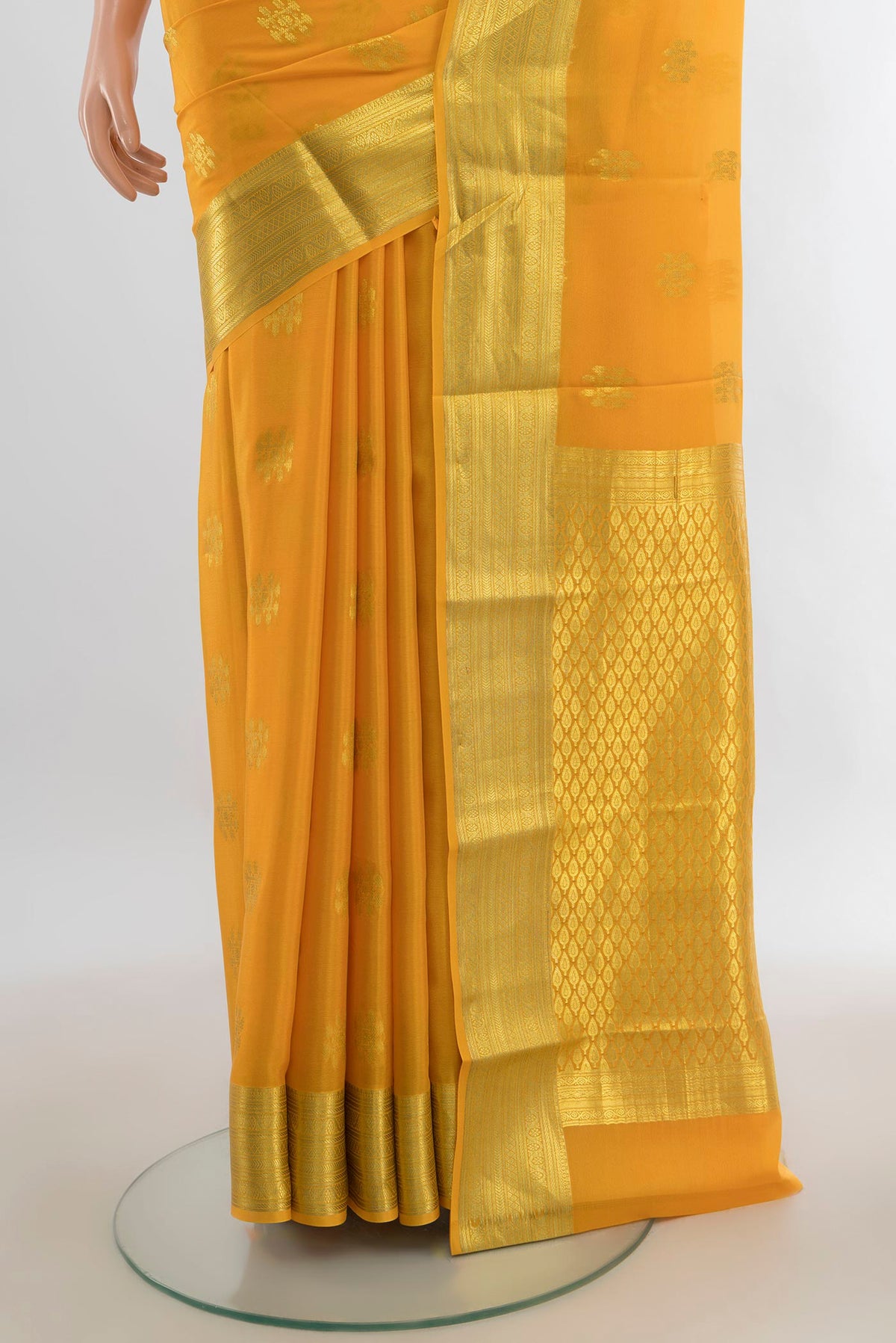 Pleats and pallu of Yellow Mysore Crepe Saree with Zari Butta on the body and Zari Border. 