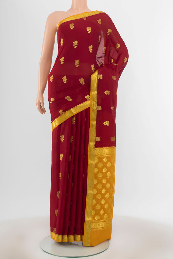 Maroon Georgette Saree with Zari Butta on the body and Silk Border.  displayed on a mannequin