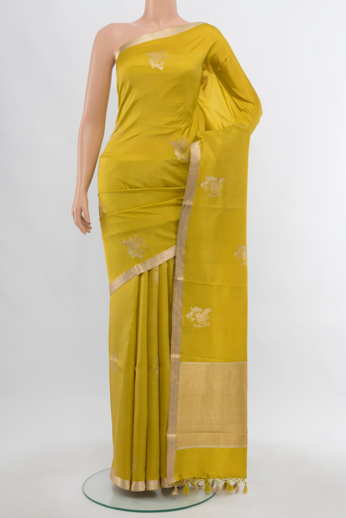 Light Green Banarasi Katan Silk Saree with Zari Butta on the body and Silk Border.  displayed on a mannequin