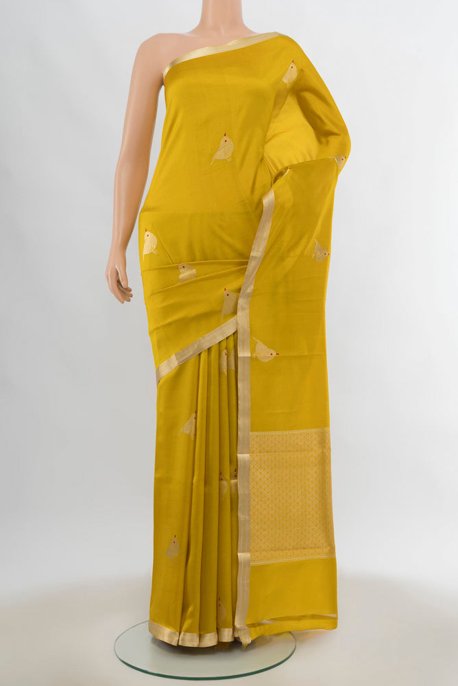Yellow Banarasi Katan Silk Saree with Zari Butta on the body and Silk Border.  displayed on a mannequin