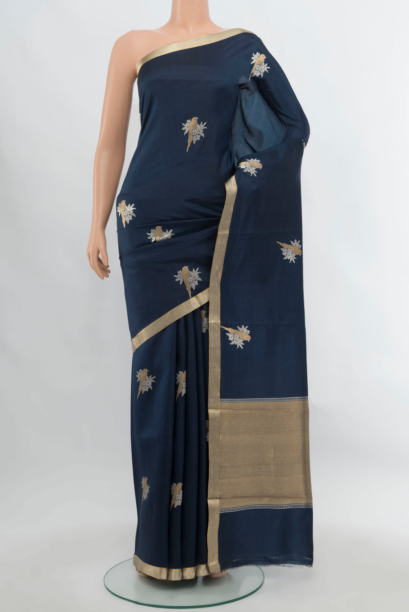 Navy Blue Banarasi Katan Silk Saree with Zari Butta on the body and Silk Border.  displayed on a mannequin