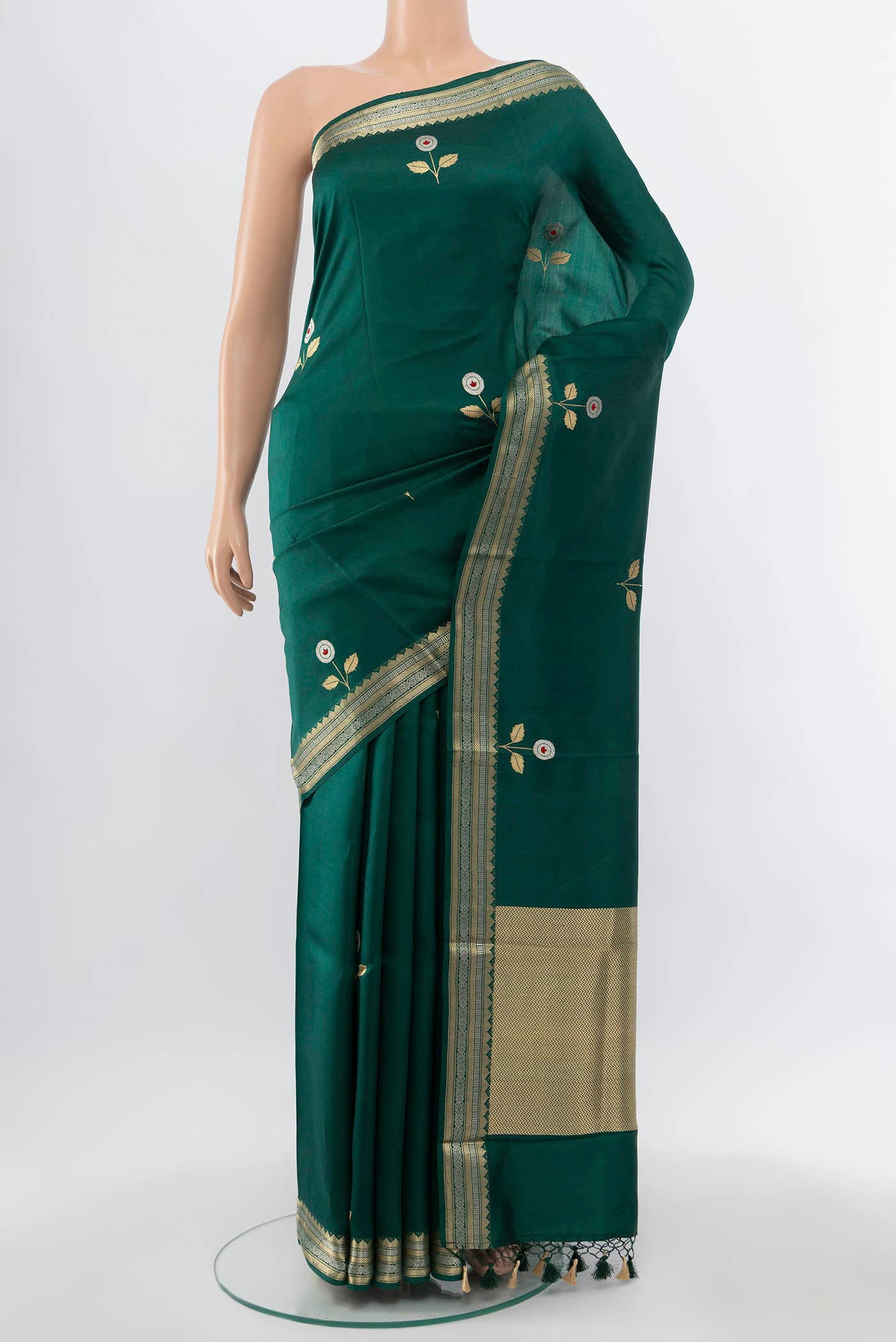 Bottle Green Banarasi Katan Silk Saree with Zari Butta on the body and Zari Border.  displayed on a mannequin