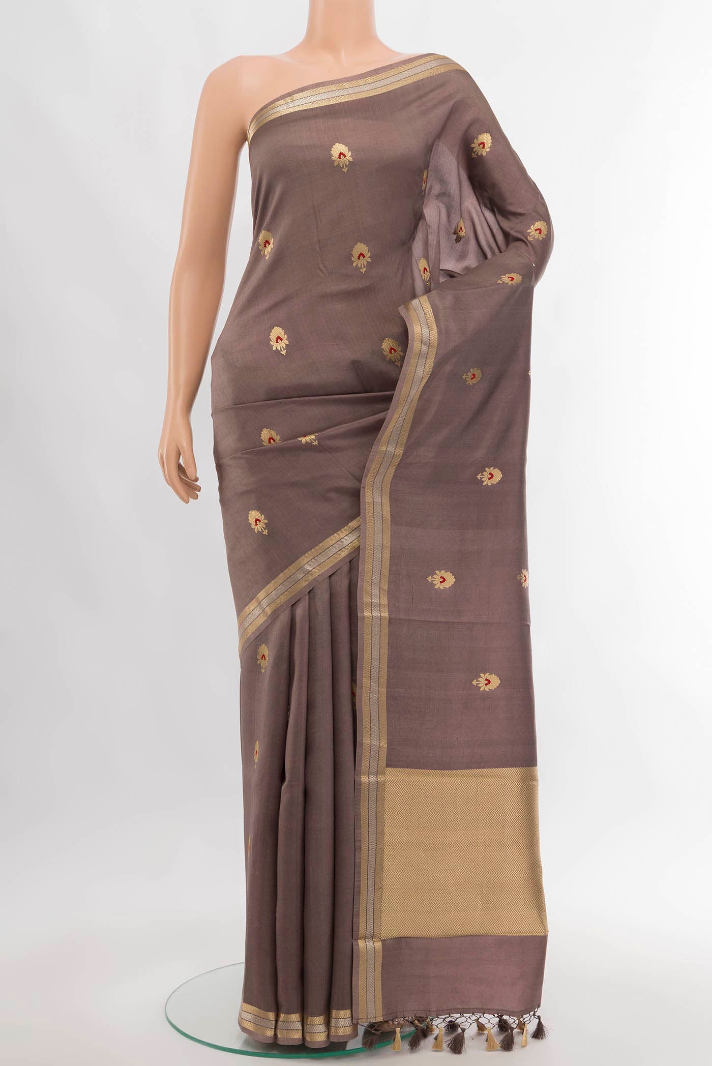 Dark Beige Banarasi Katan Silk Saree with Zari Butta on the body and Silk Border.  displayed on a mannequin