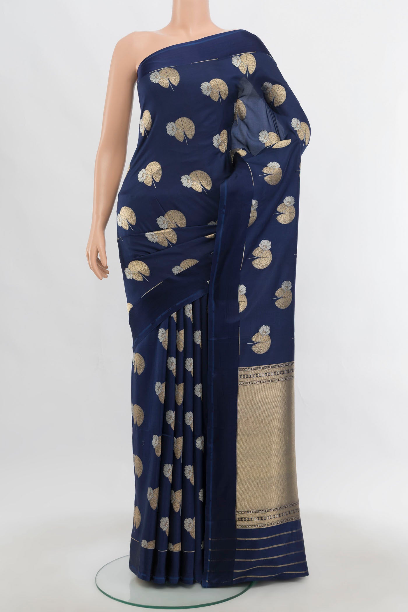 Navy Blue Banarasi Katan Silk Saree with Zari Butta on the body and Zari Border.  displayed on a mannequin