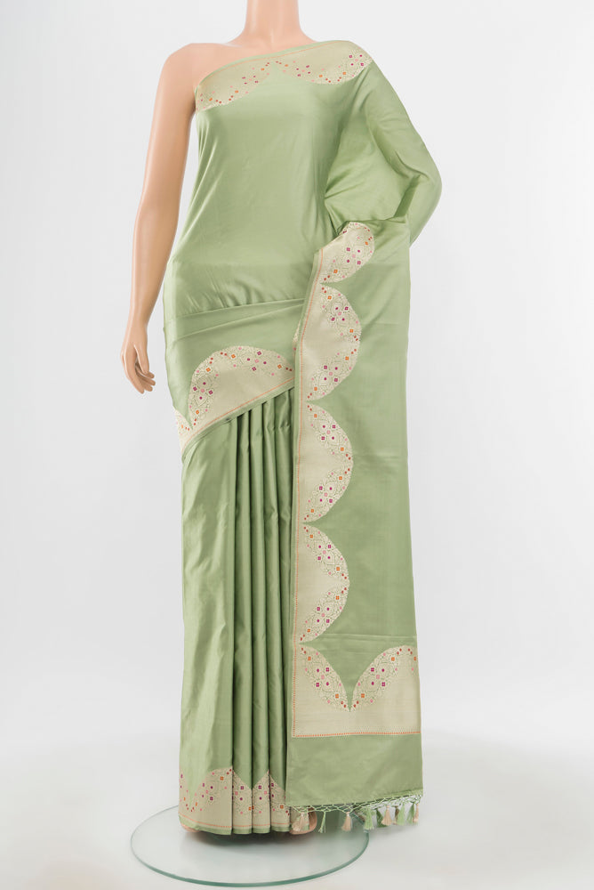 Pure Silk Pure Zari Pista Green Banarasi Saree with Zari Butta on the body and Silk Border.  displayed on a mannequin