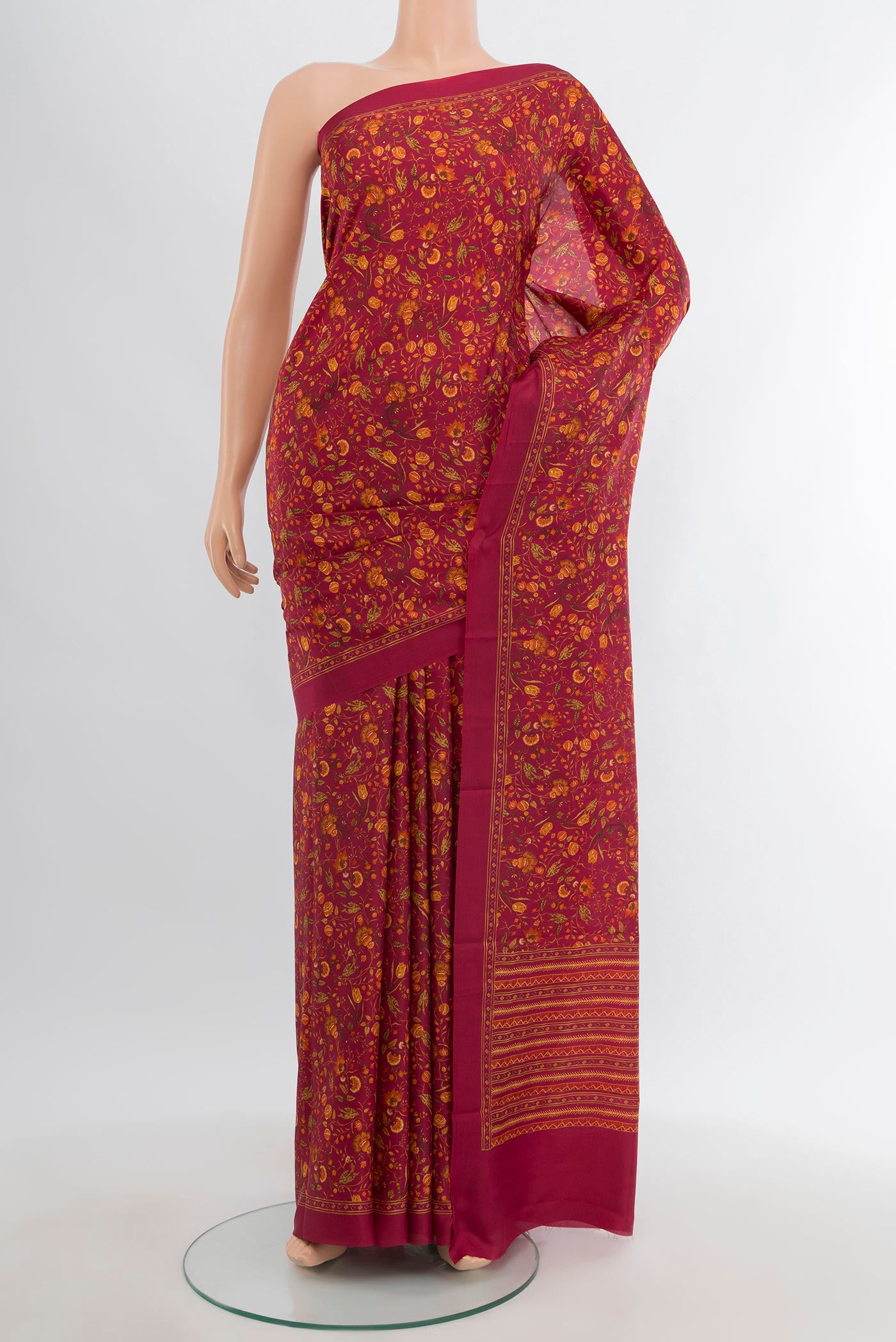 Red Printed Silk Saree with Floral Print on the body and Printed Border.  displayed on a mannequin