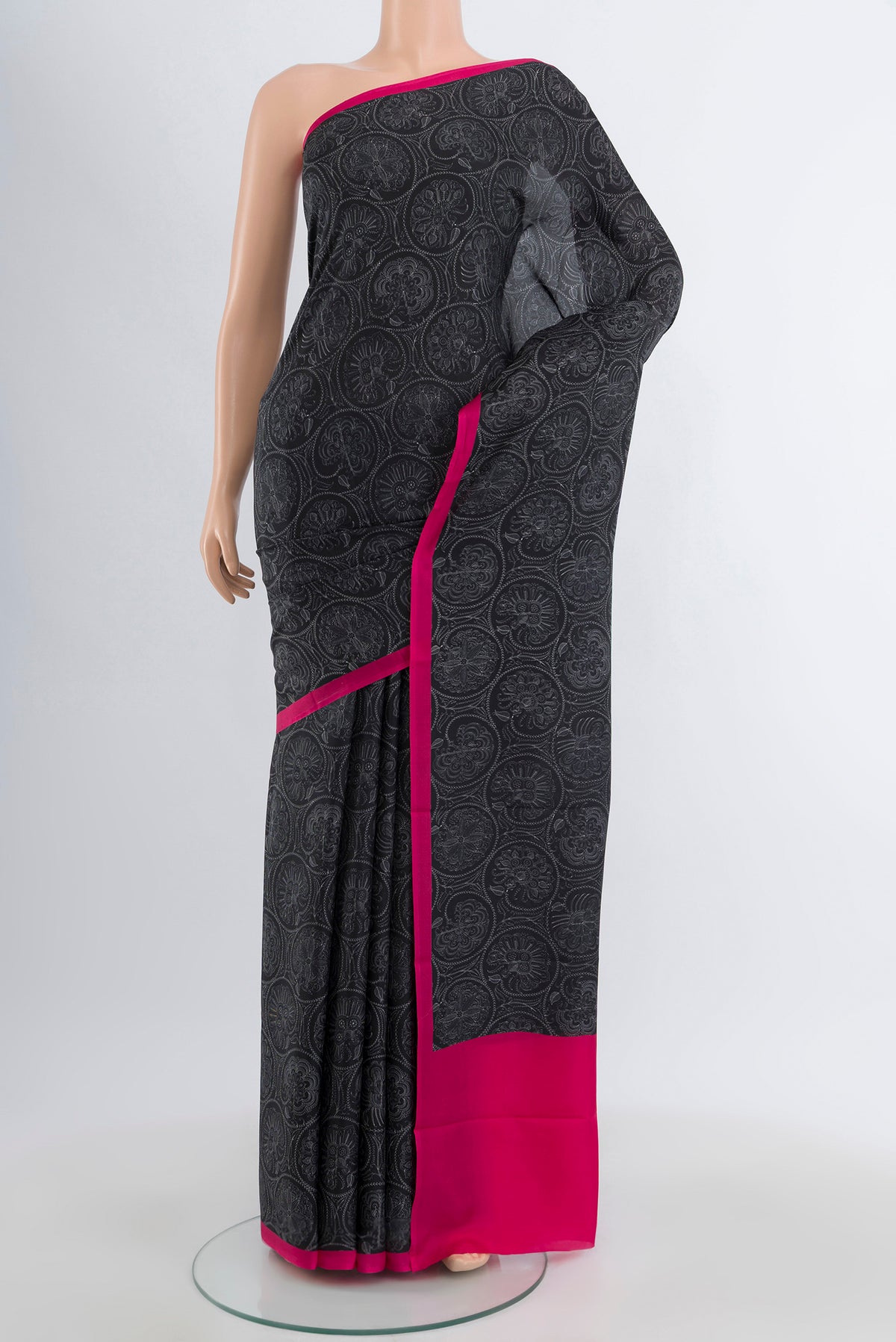 Black Printed Silk Saree with Floral Print on the body and Plain Border.  displayed on a mannequin