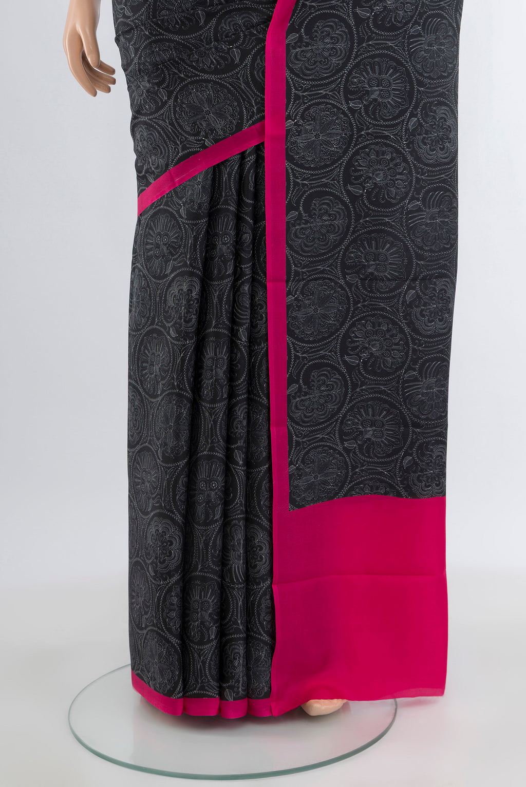 Pleats and pallu of Black Printed Silk Saree with Floral Print on the body and Plain Border. 