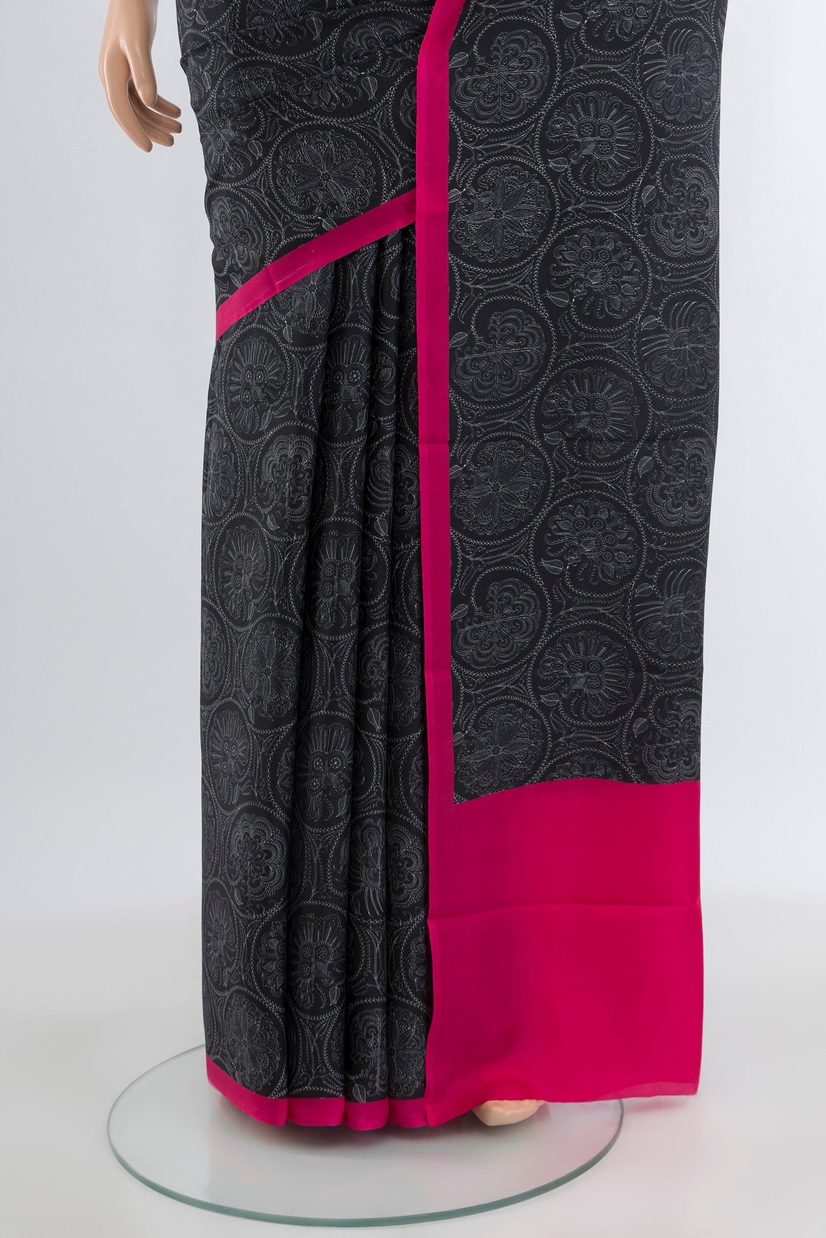 Pleats and pallu of Black Printed Silk Saree with Floral Print on the body and Plain Border. 
