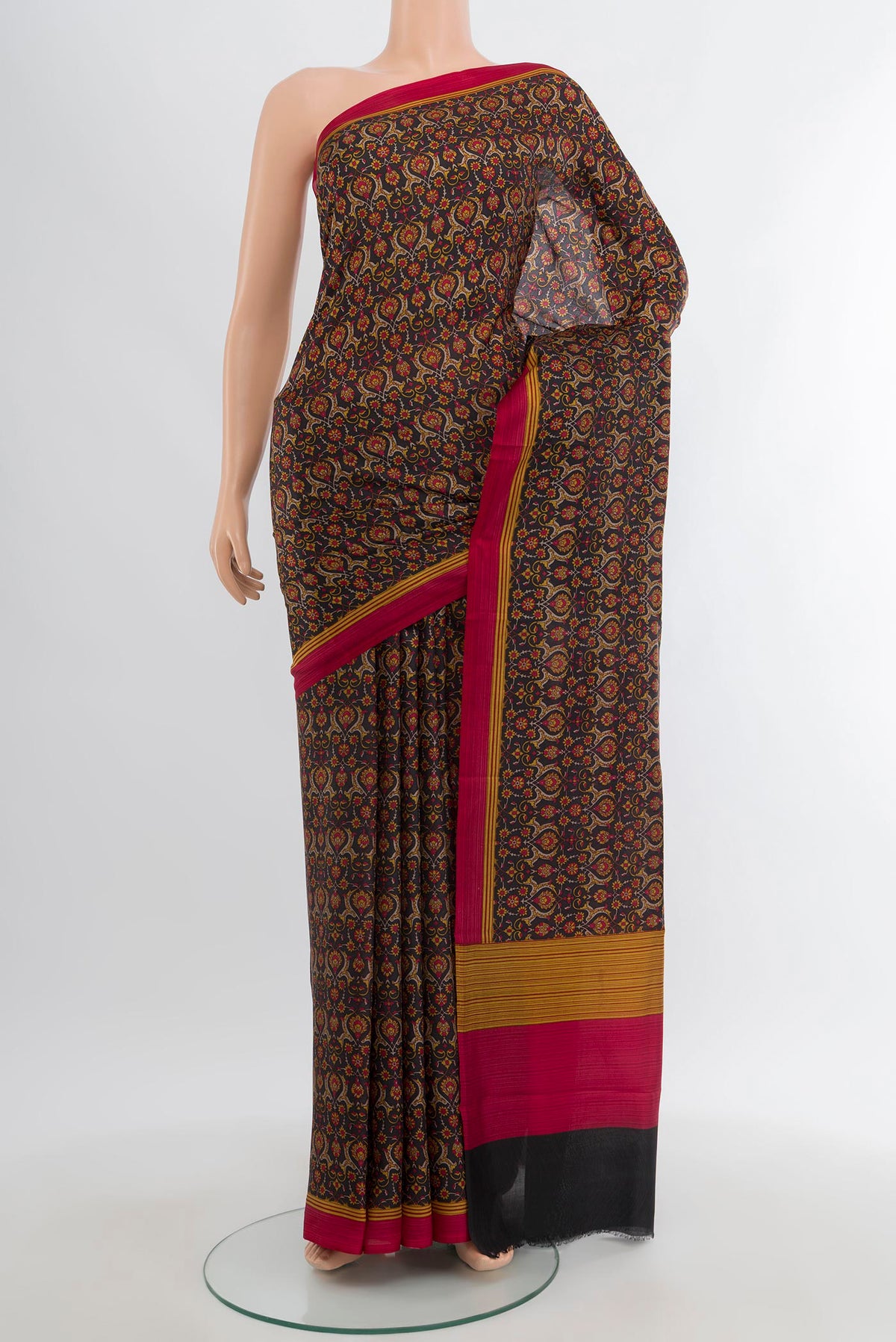 Black Printed Silk Saree with Floral Print on the body and Printed Border.  displayed on a mannequin