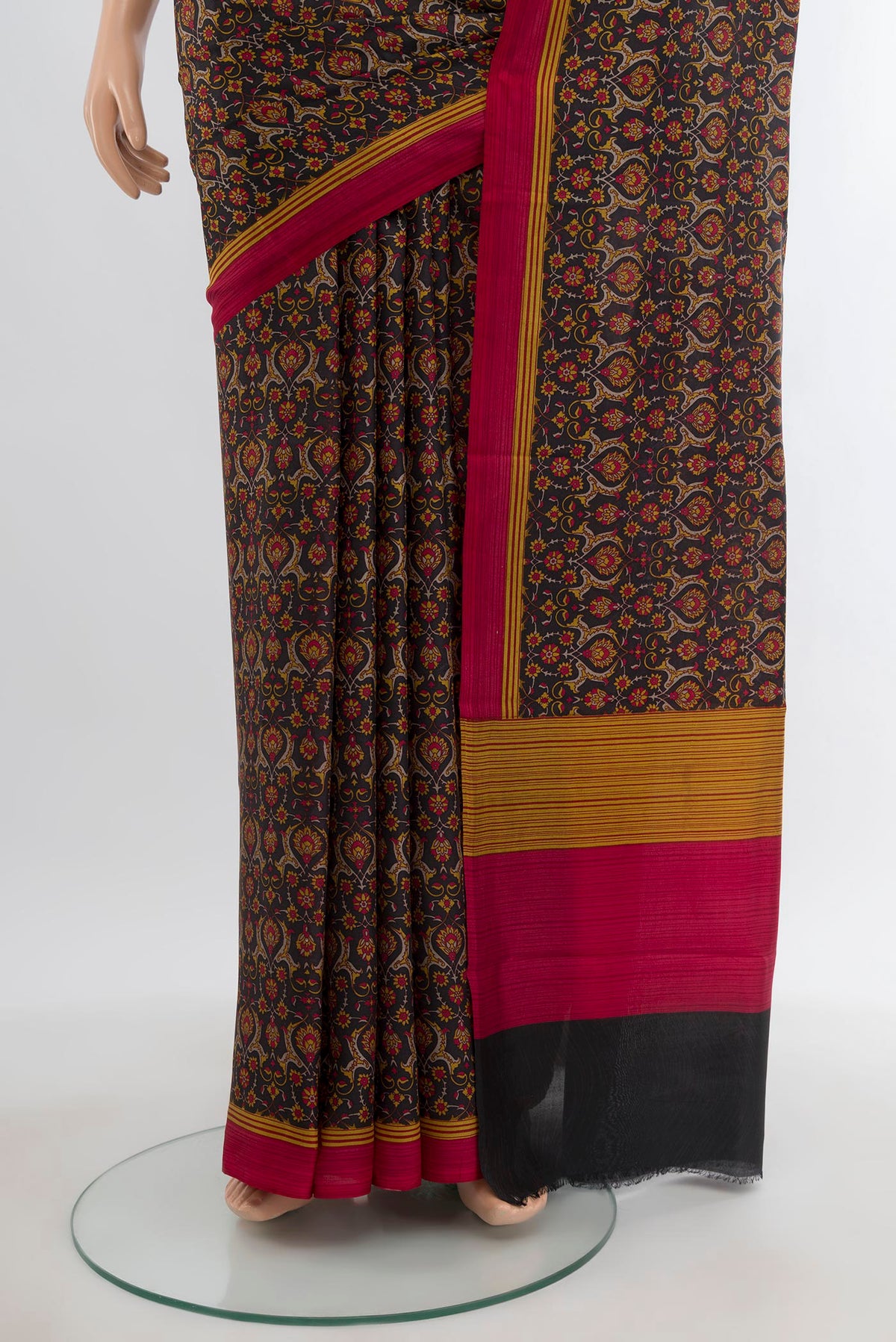 Pleats and pallu of Black Printed Silk Saree with Floral Print on the body and Printed Border. 