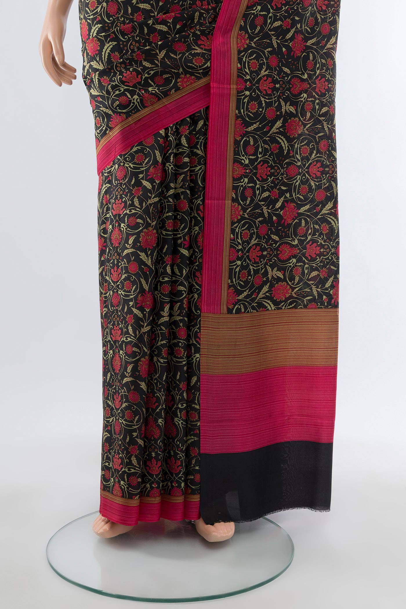 Pleats and pallu of Black Printed Silk Saree with Floral Print on the body and Printed Border. 