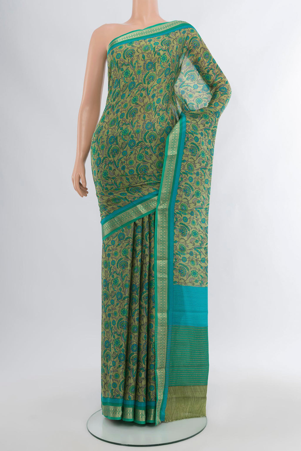 Sage Green Mysore Crepe Saree with Floral Print on the body and Zari Border.  displayed on a mannequin