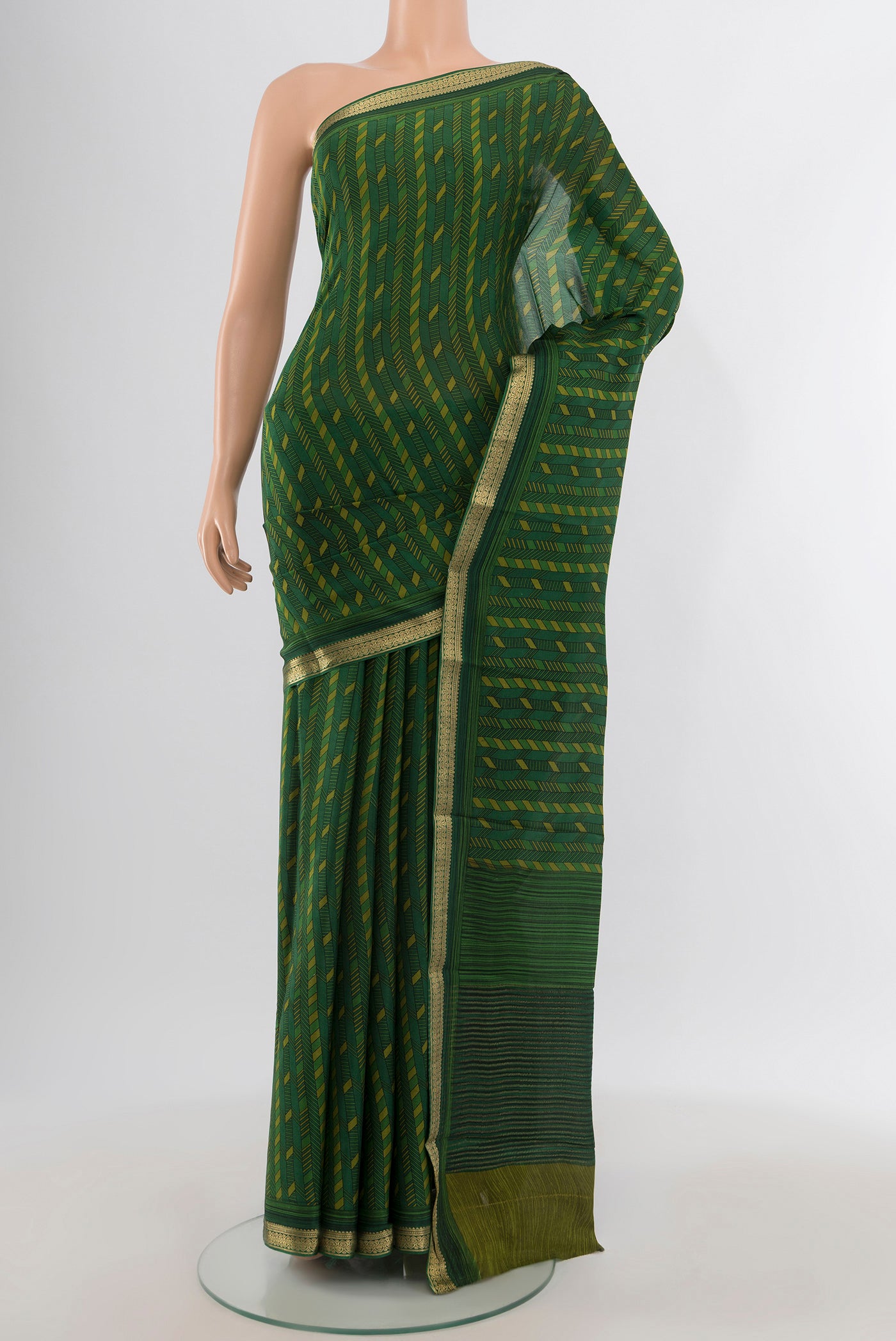 Green Crepe Saree with Floral Print on the body and Zari Border.  displayed on a mannequin