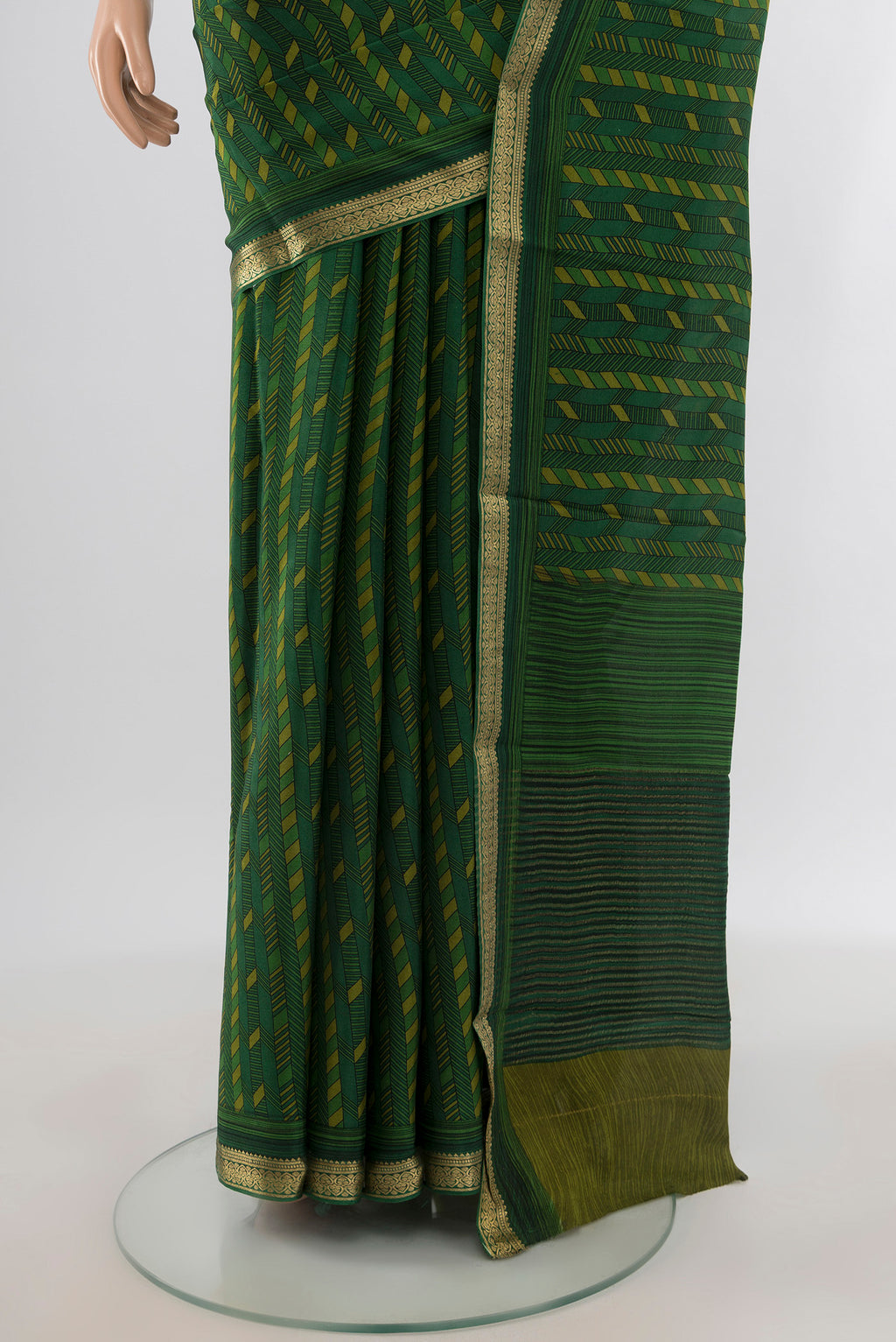 Pleats and pallu of Green Crepe Saree with Floral Print on the body and Zari Border. 
