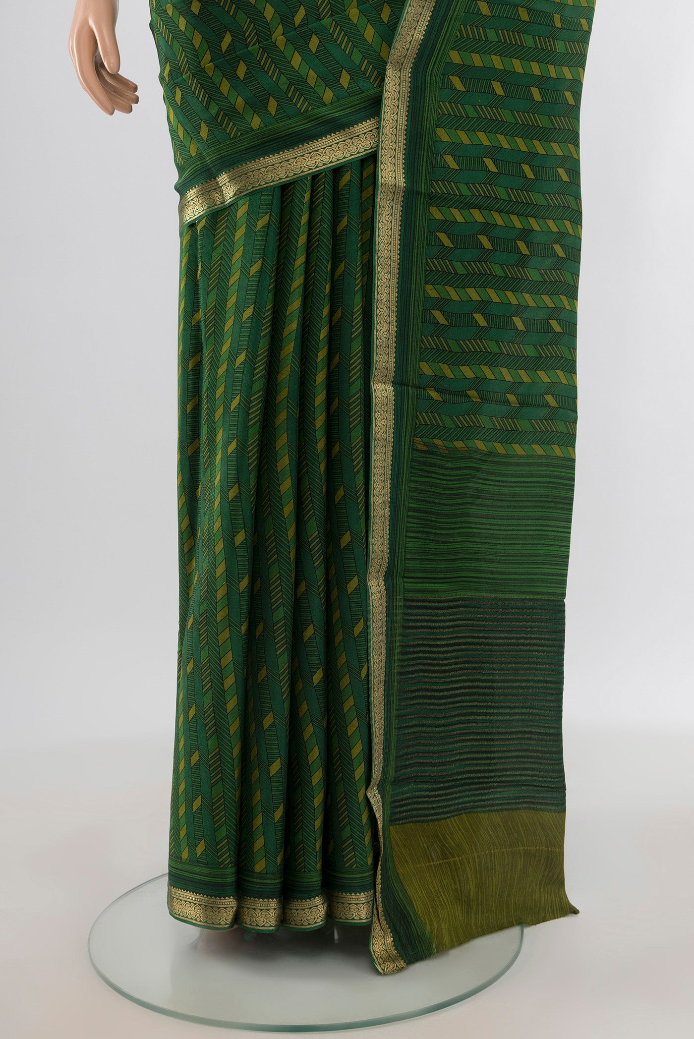 Pleats and pallu of Green Crepe Saree with Floral Print on the body and Zari Border. 