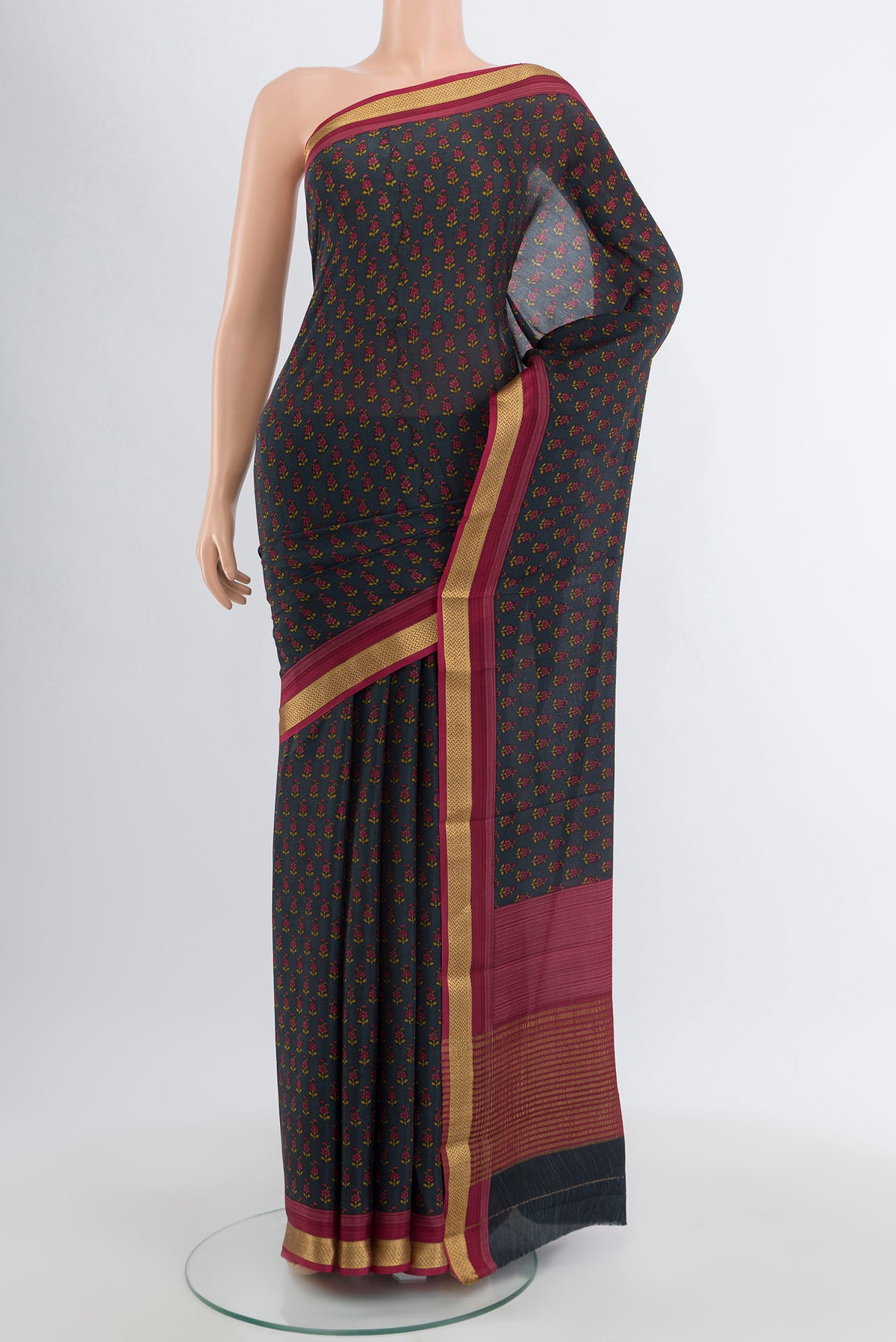 Black Crepe Saree with Floral Print on the body and Zari Border.  displayed on a mannequin