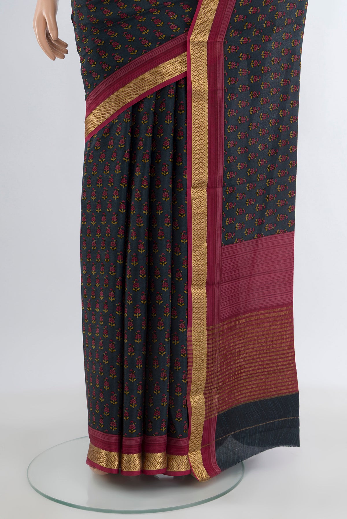 Pleats and pallu of Black Crepe Saree with Floral Print on the body and Zari Border. 
