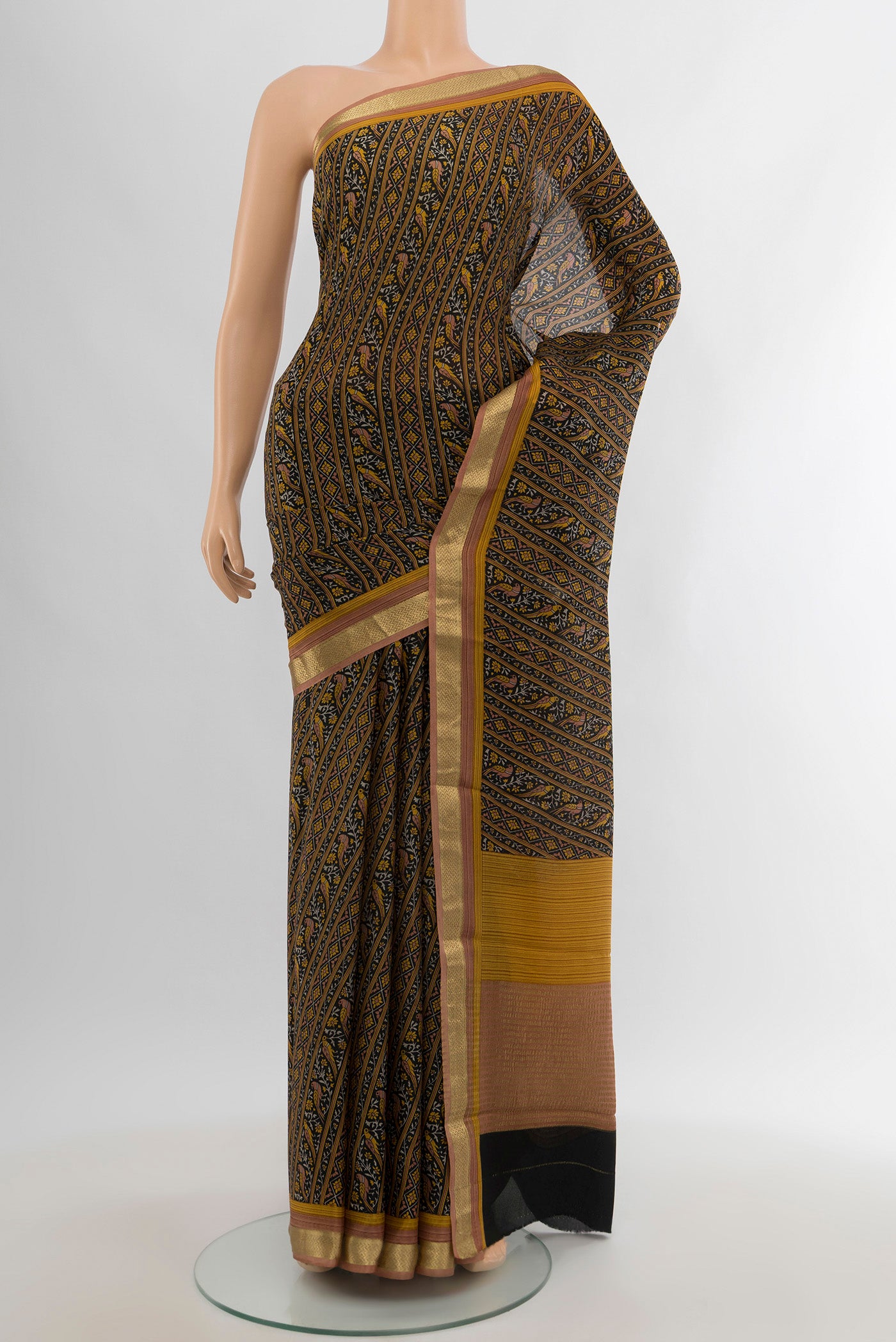 Black Crepe Saree with Floral Print on the body and Zari Border.  displayed on a mannequin