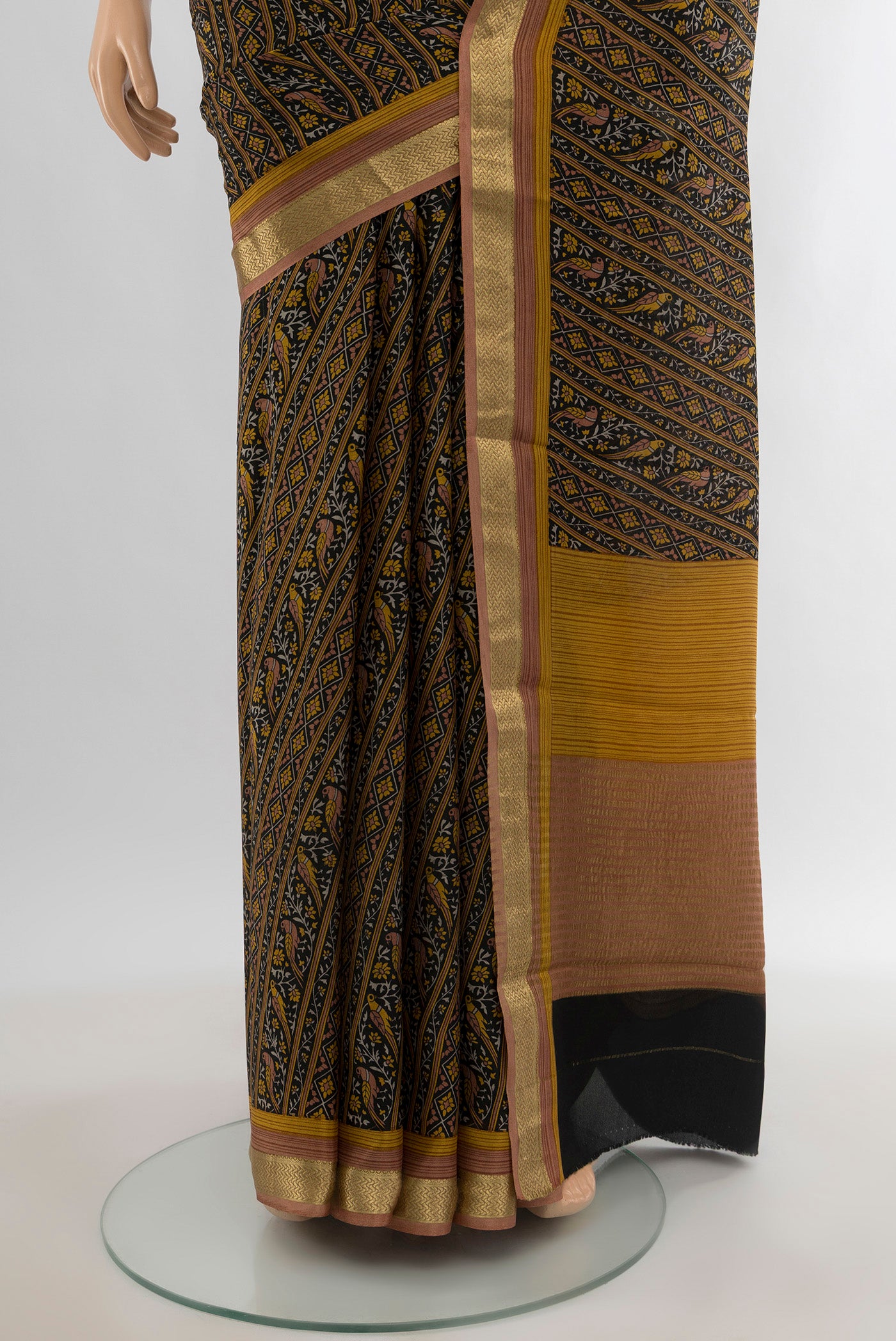 Pleats and pallu of Black Crepe Saree with Floral Print on the body and Zari Border. 