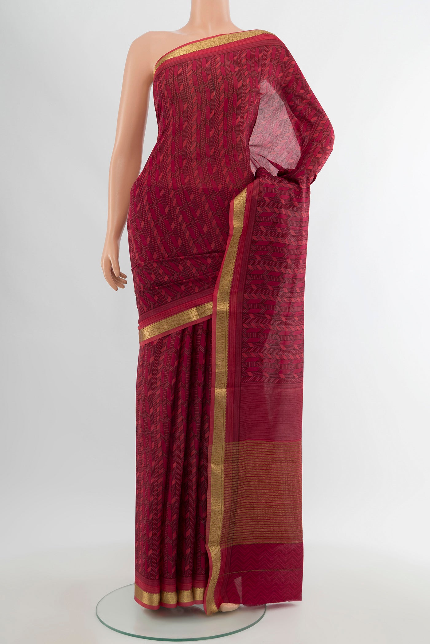 Maroon Crepe Saree with Floral Print on the body and Zari Border.  displayed on a mannequin