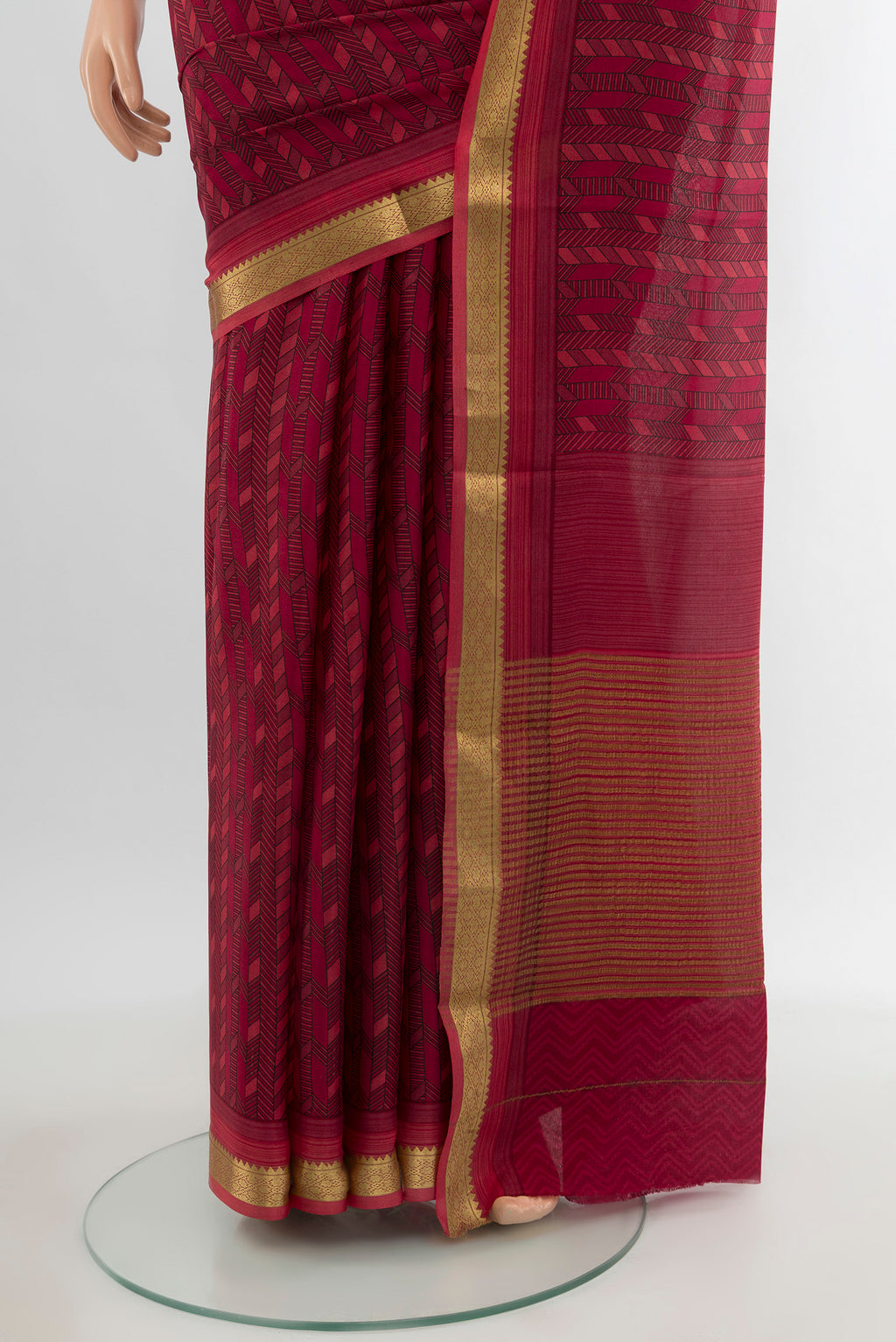 Pleats and pallu of Maroon Crepe Saree with Floral Print on the body and Zari Border. 