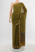 Mustard Mysore Crepe Saree with Floral Print on the body and Zari Border.  displayed on a mannequin