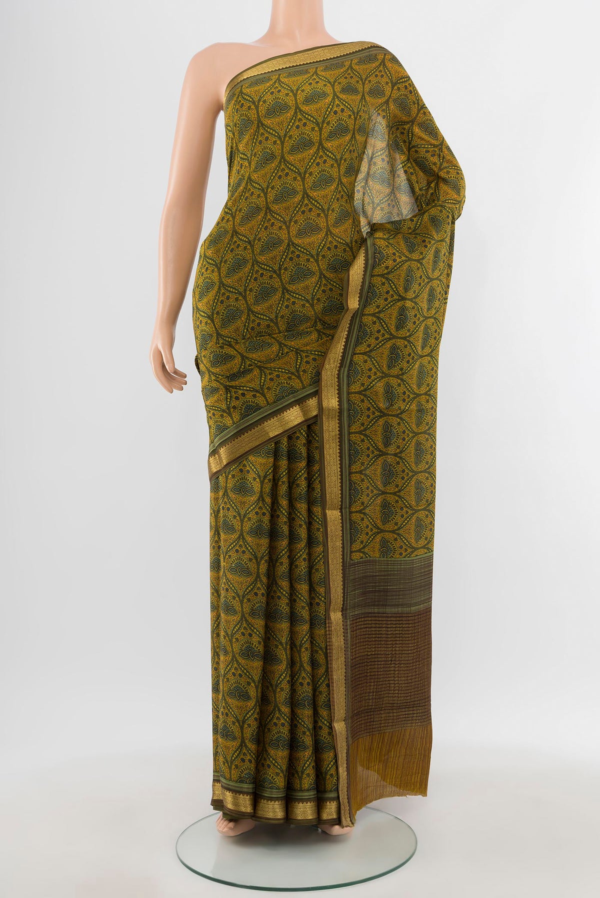 Mustard Mysore Crepe Saree with Floral Print on the body and Zari Border.  displayed on a mannequin