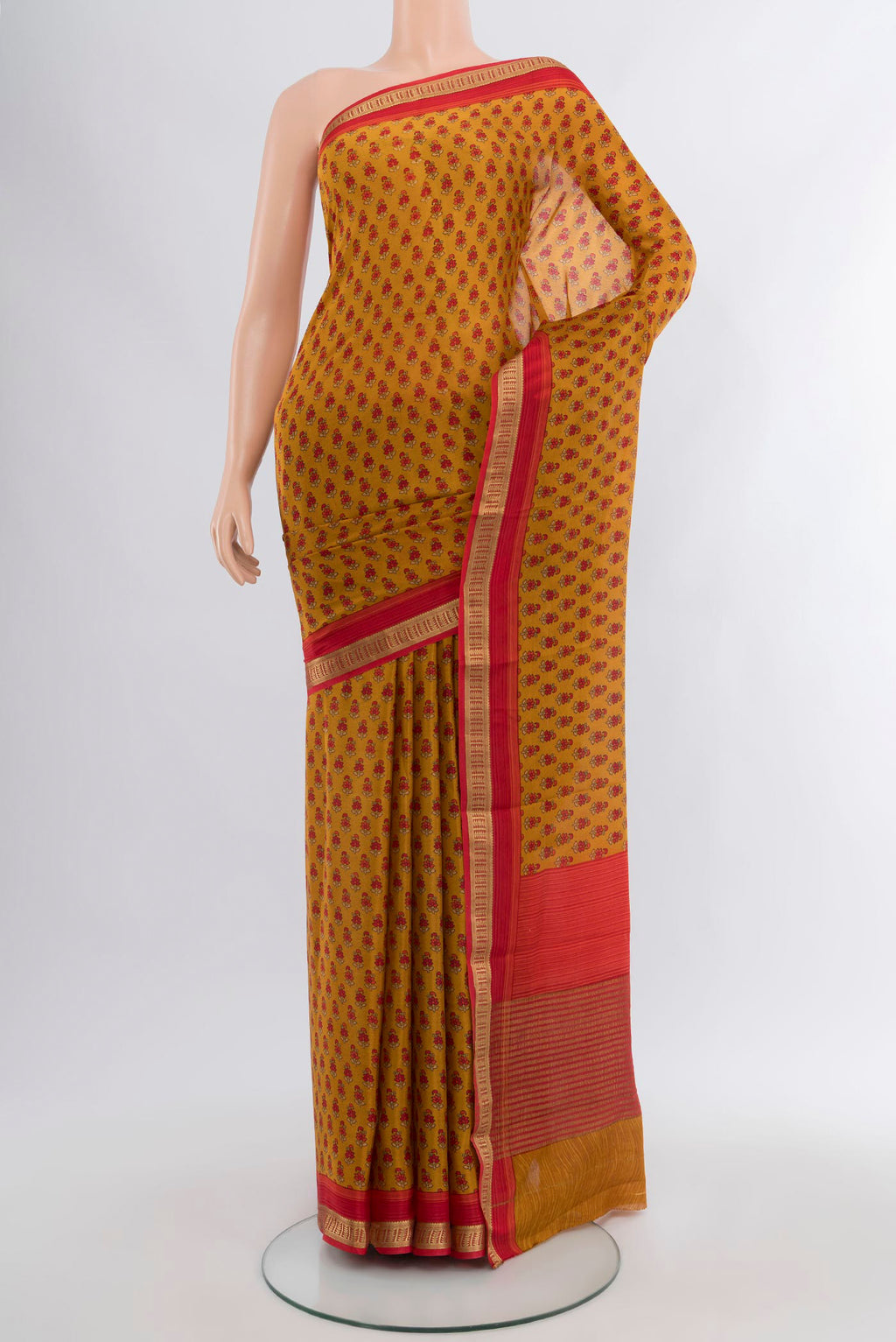 Mustard Mysore Crepe Saree with Floral Print on the body and Zari Border.  displayed on a mannequin