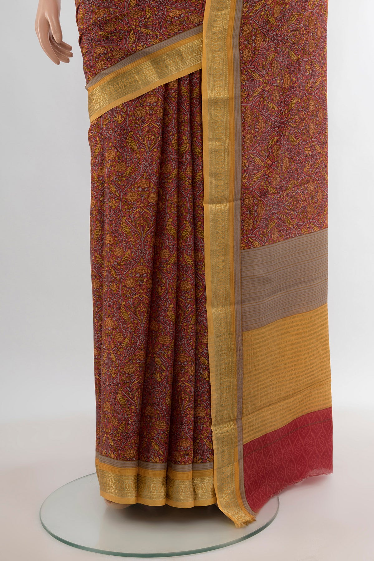 Pleats and pallu of Coral Crepe Saree with Floral Print on the body and Zari Border. 